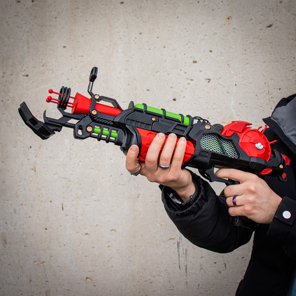 Full side view of the red, black and green Ray Gun Mk II-inspired cosplay prop