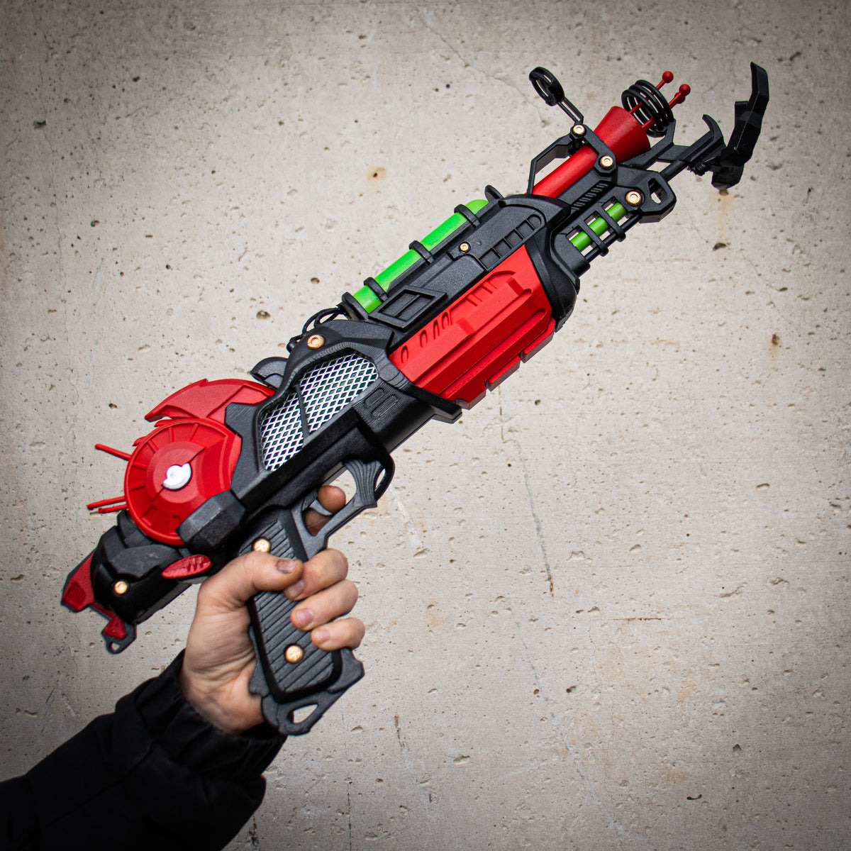 Hand-held finished 3D printed Ray Gun Mk II-inspired cosplay prop in red, black, green and gold