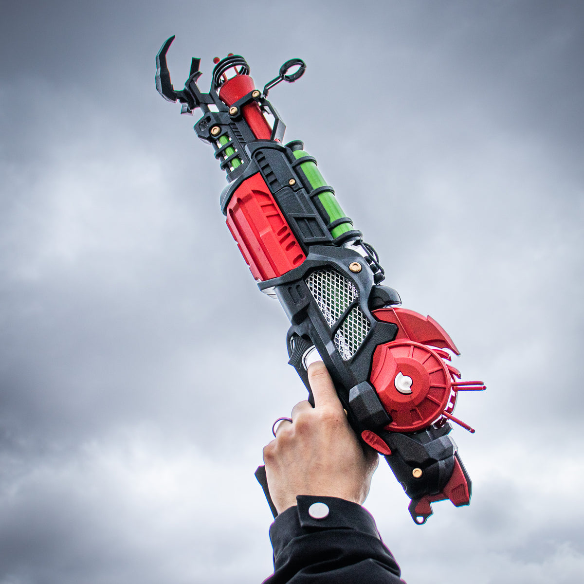 Finished Ray Gun Mk II-inspired cosplay prop raised against the sky