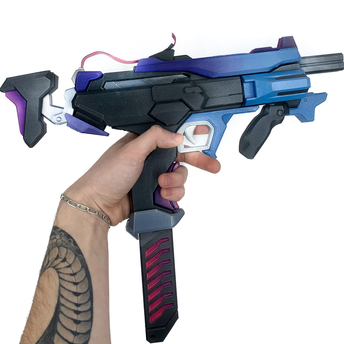 Full side view of finished Sombra Machine Pistol-inspired 3D printed cosplay prop photographed from another angle